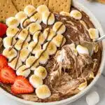 A high-protein s’mores dip in a round ceramic bowl