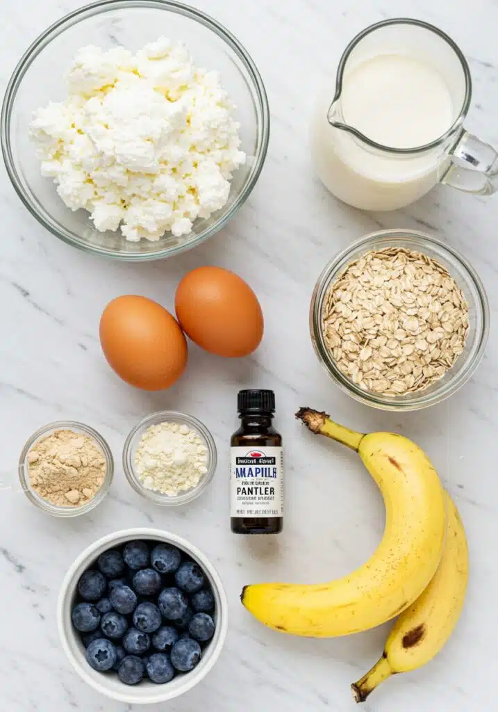 Flat lay of all ingredients for blueberry cottage cheese breakfast bake