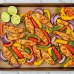 sheet pan fajitas meal prep served on a parchment-lined baking tray