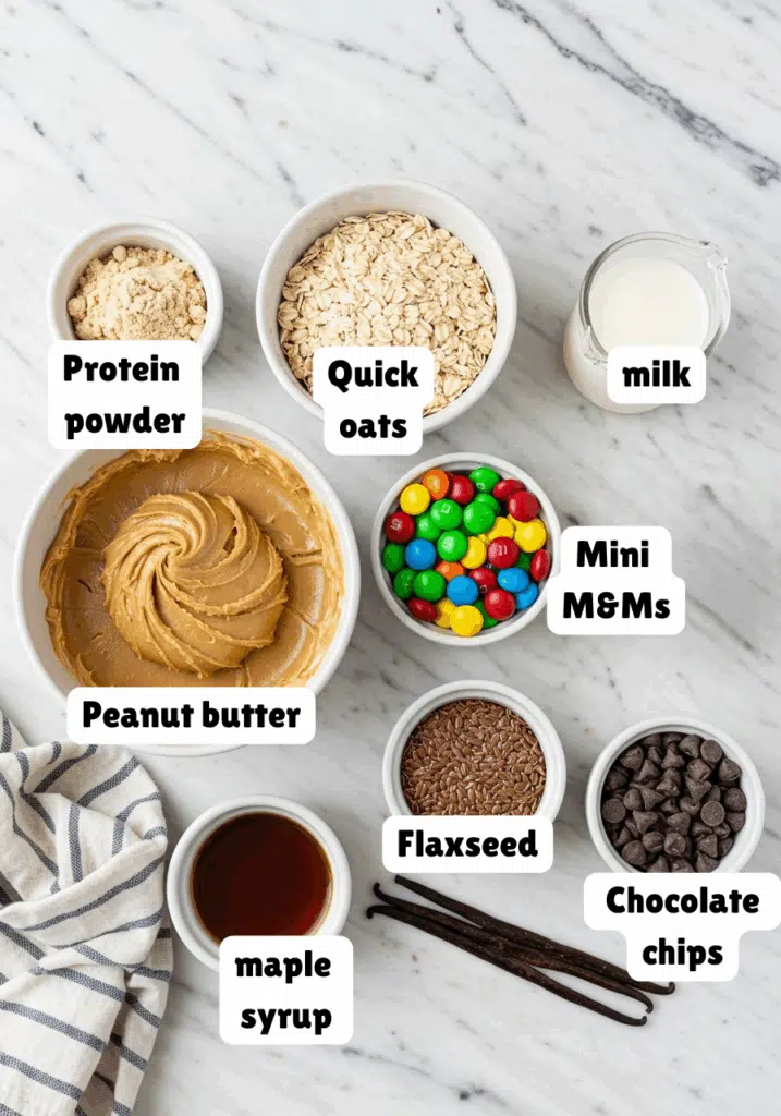Ingredients for monster cookie protein balls laid out on a marble countertop